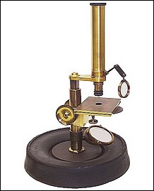 J & W Grunow, New York #267. Small microscope on a wood and iron bas Small microscope on a wood and iron base c. 1864.